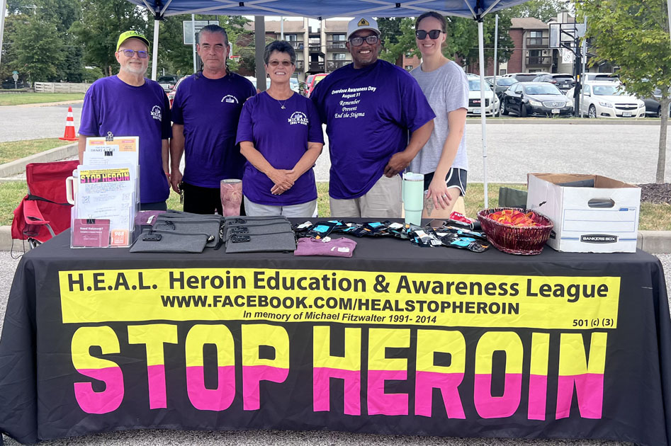 Staff at H.E.A.L exhibit table.