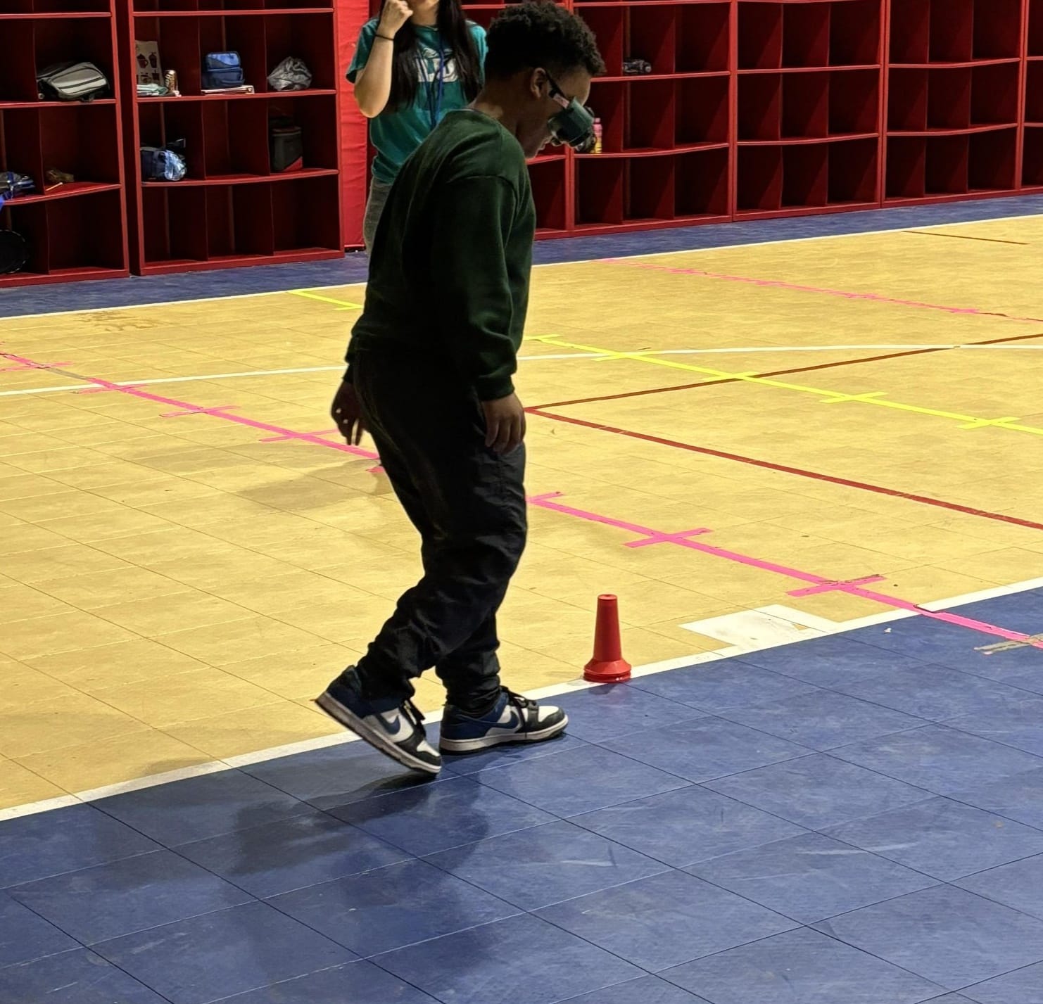Participant wearing "drunk goggles" in obstacle course